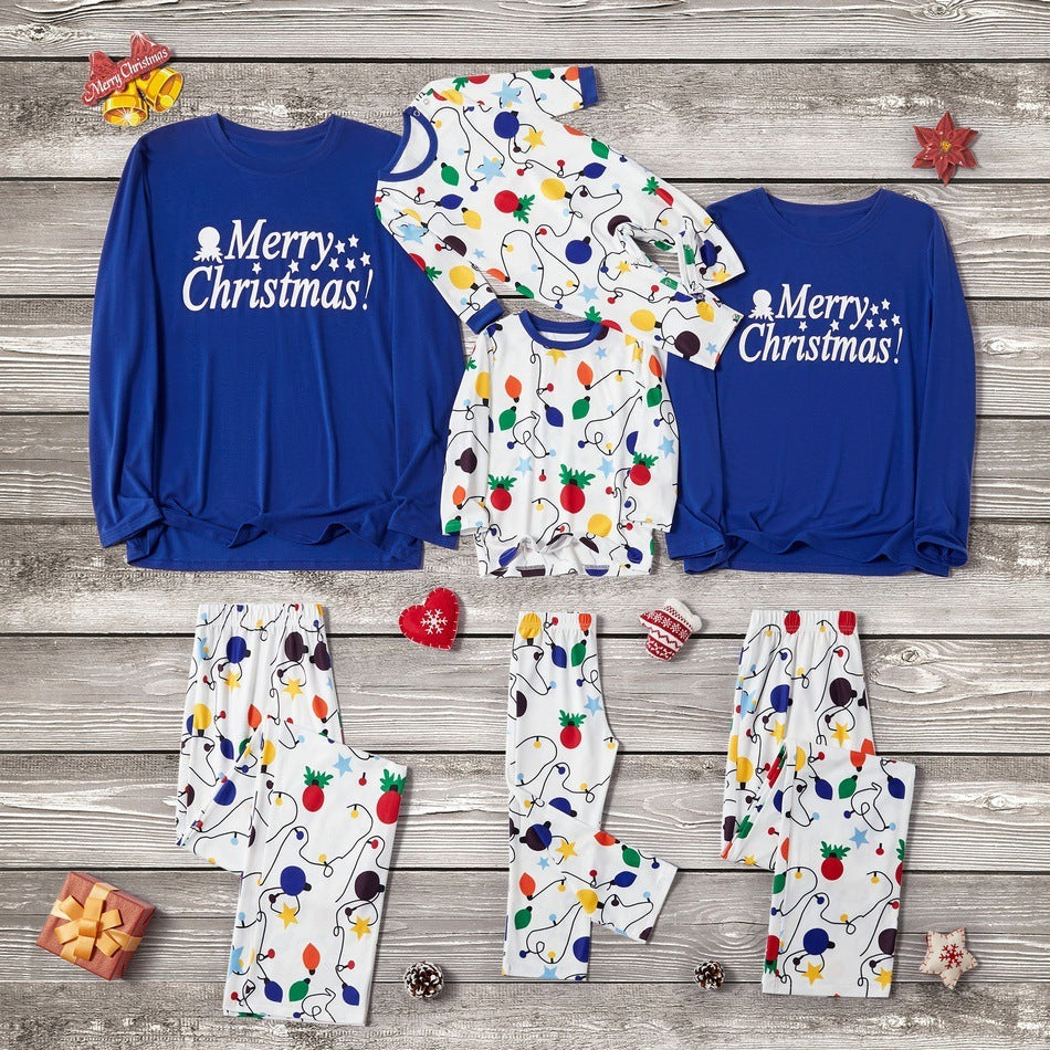 Christmas-themed children's clothing set on a wooden background