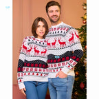 Two people wearing Christmas-themed sweaters in front of a decorated tree.
