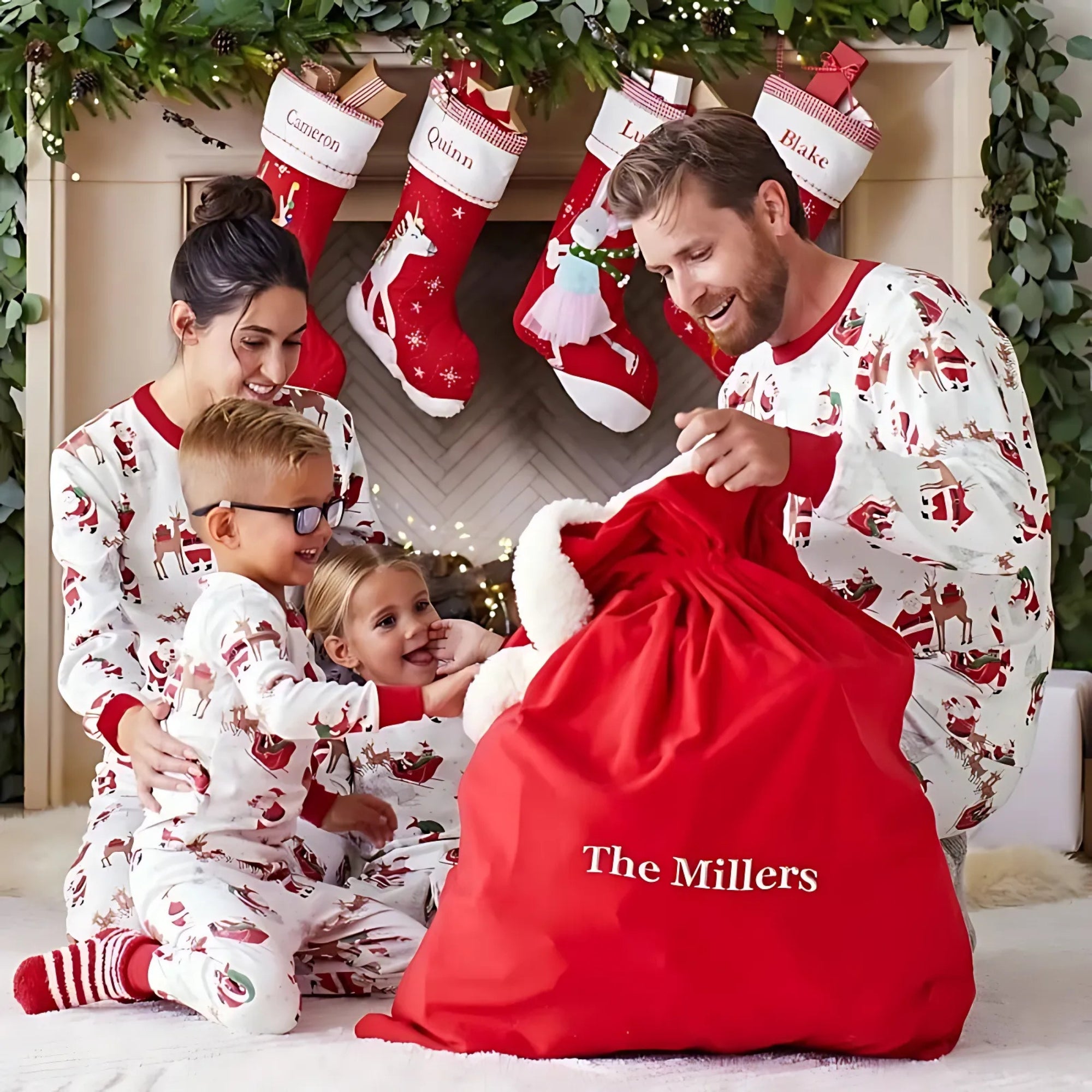 Family in matching pajamas with a red sack labeled 'The Millers' in front of Christmas stockings.